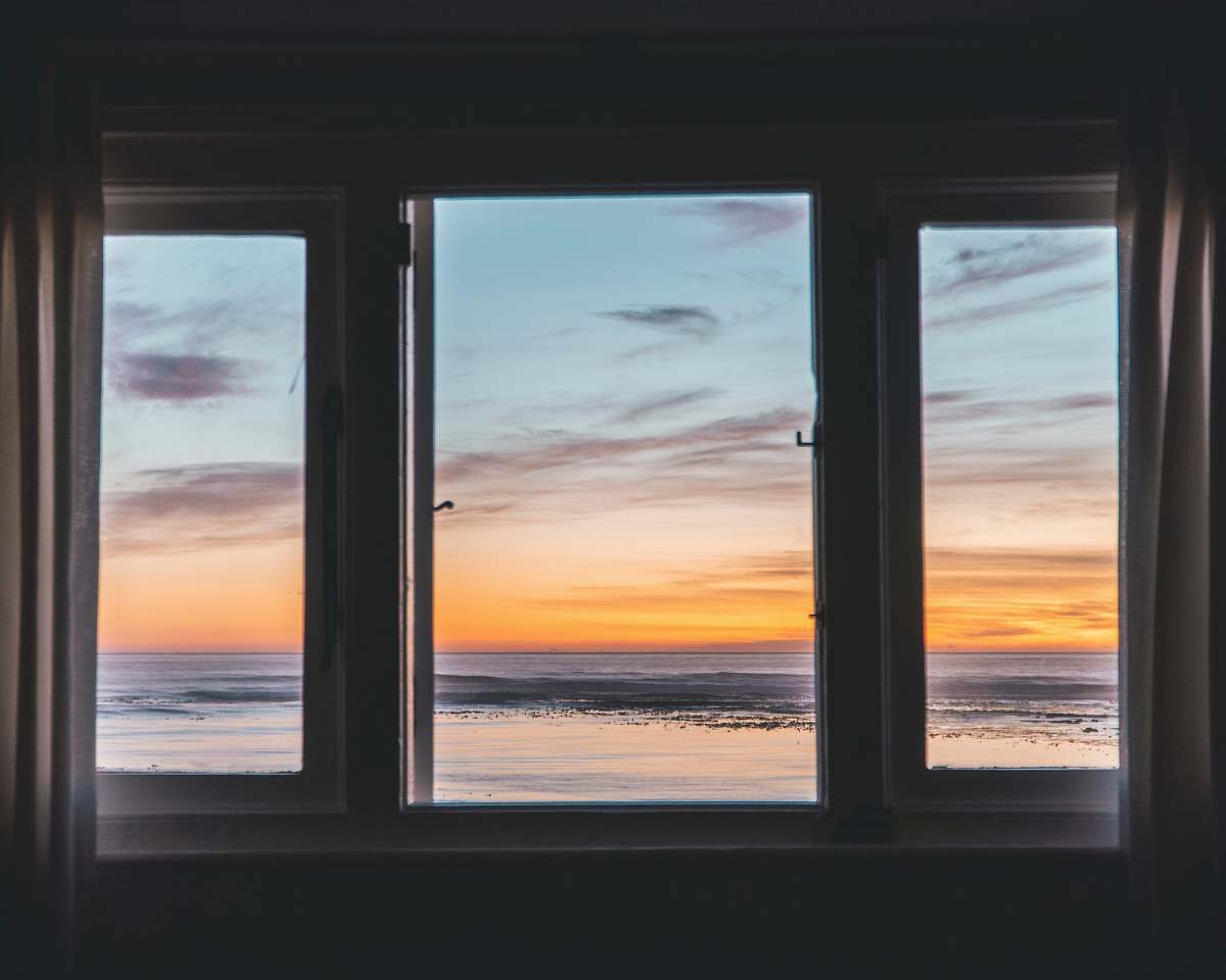 picture window white wooden framed glass window near body of water aircraft